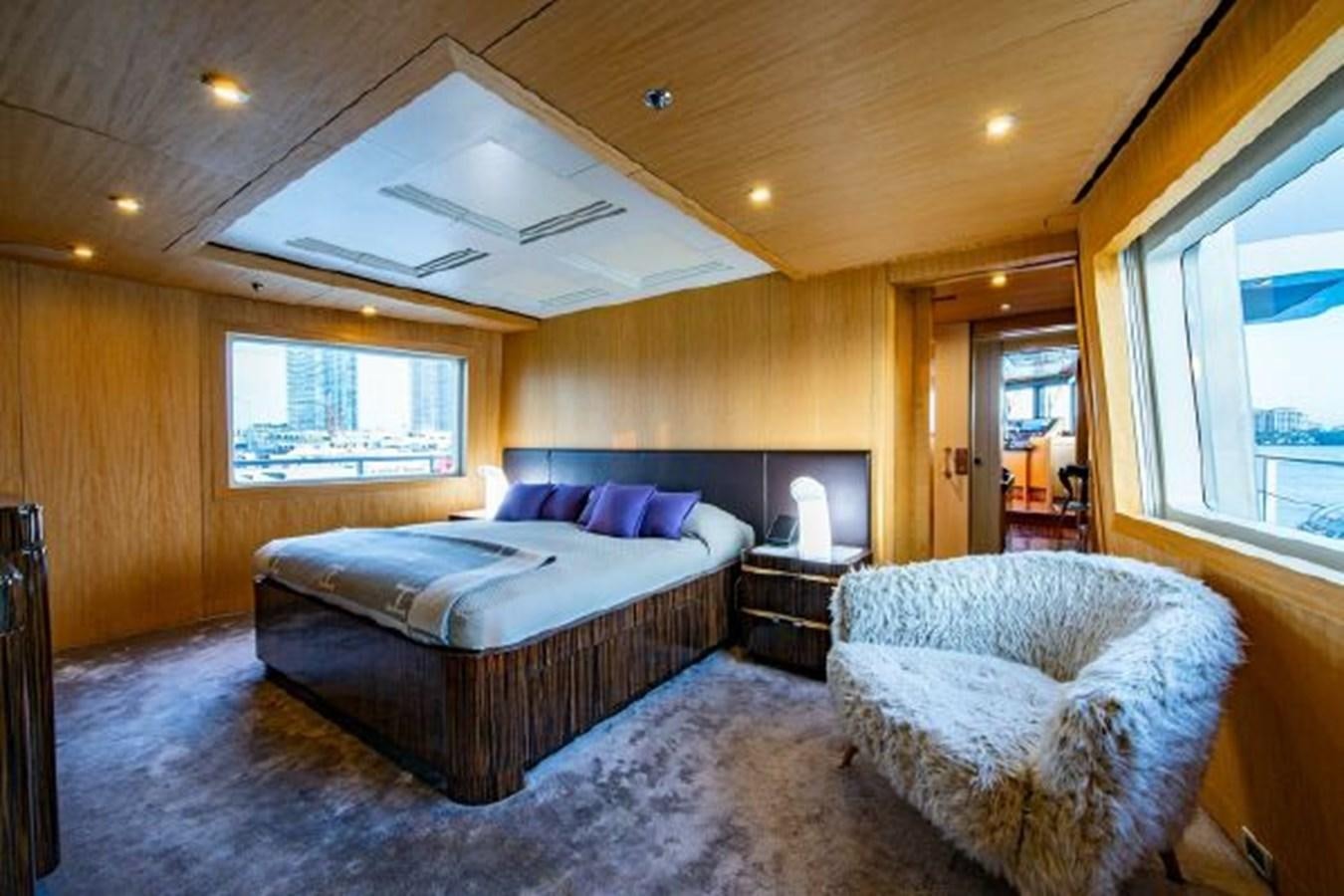 a bedroom with a bed and a chair aboard 174 OCEANFAST MOTOR YACHT Yacht for Sale