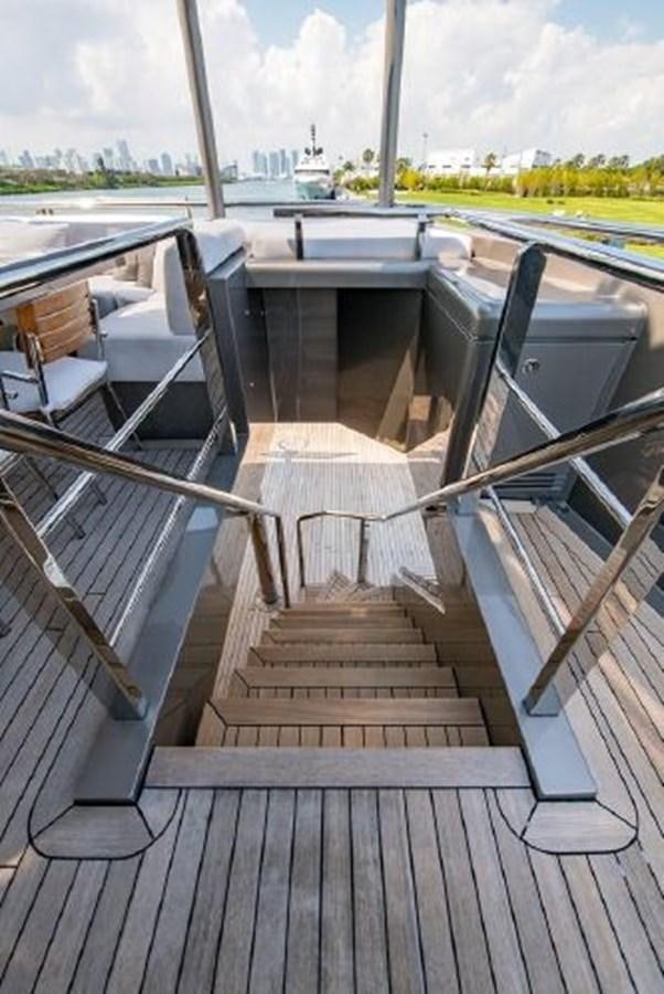 a wooden walkway with a railing and a railing with a city in the background aboard 174 OCEANFAST MOTOR YACHT Yacht for Sale