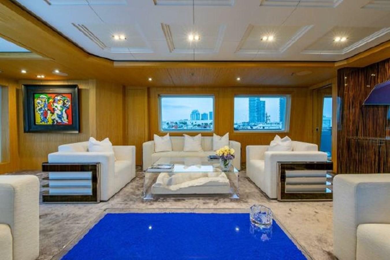 a living room with a blue table aboard 174 OCEANFAST MOTOR YACHT Yacht for Sale