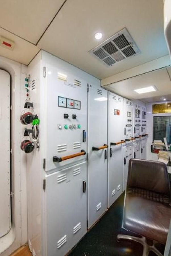 a room with a chair and a fridge aboard 174 OCEANFAST MOTOR YACHT Yacht for Sale