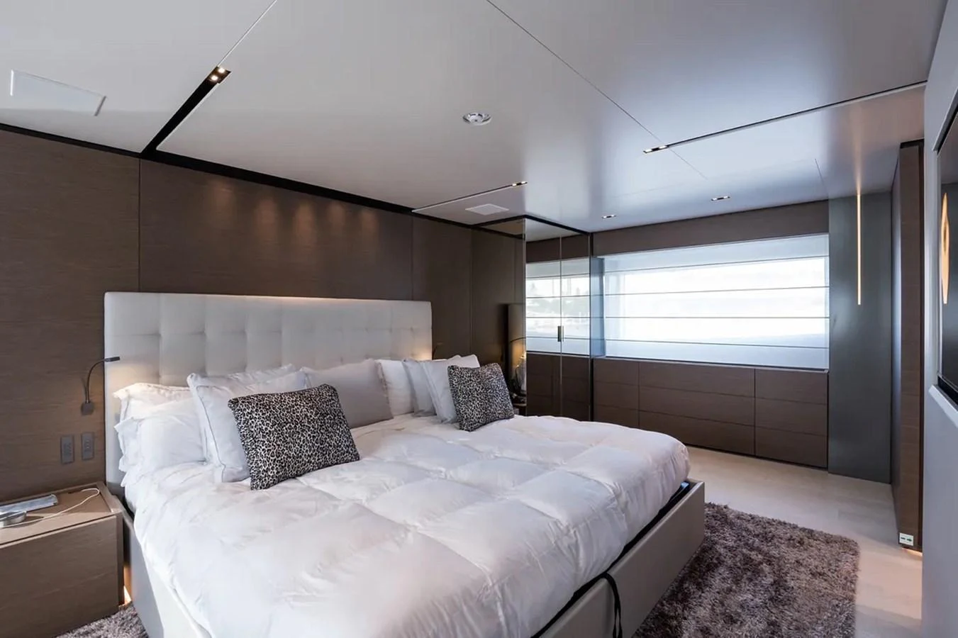 a bedroom with a bed and a window aboard GIOIA Yacht for Sale