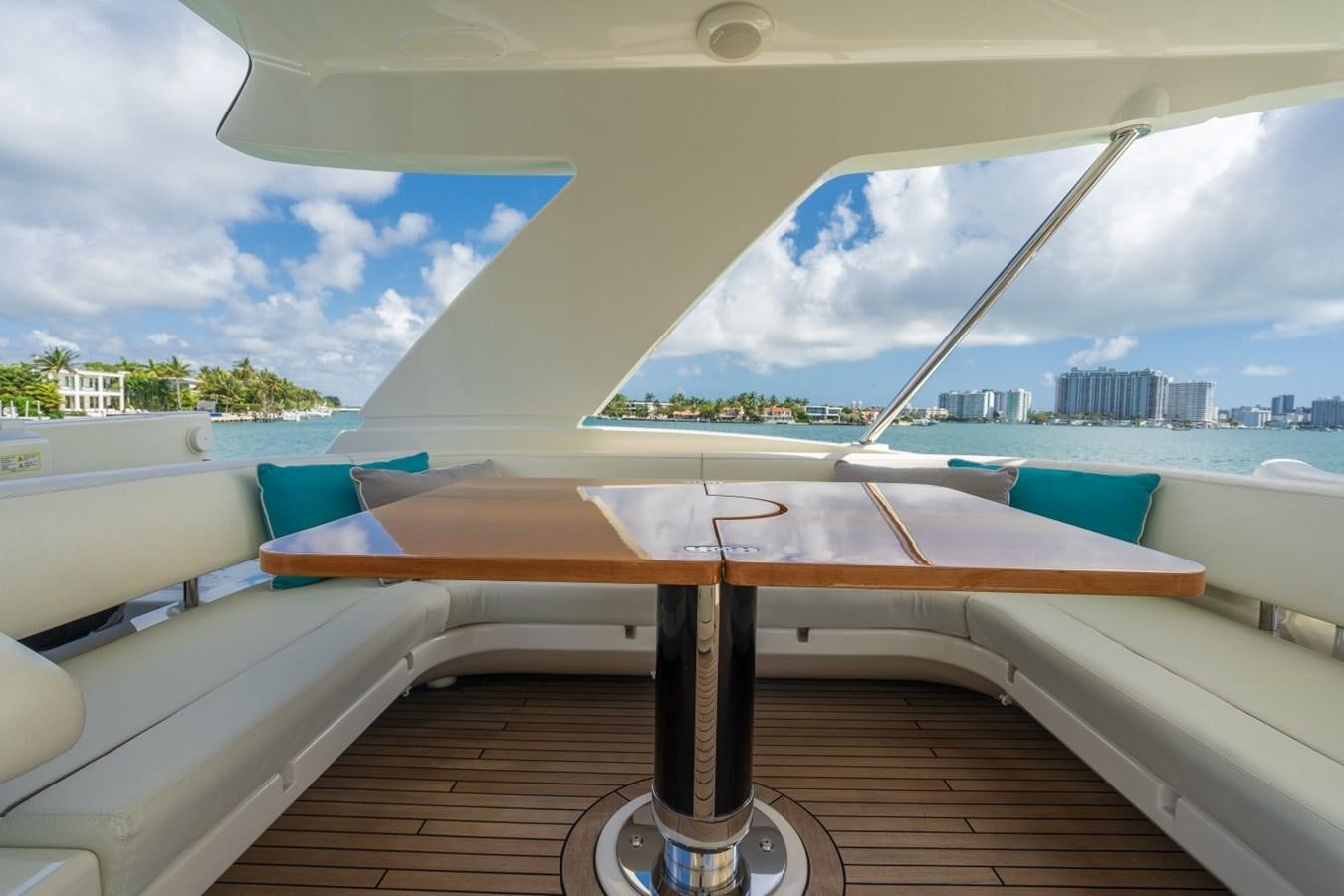 a wood table on a boat aboard NAMEDROPPER Yacht for Sale