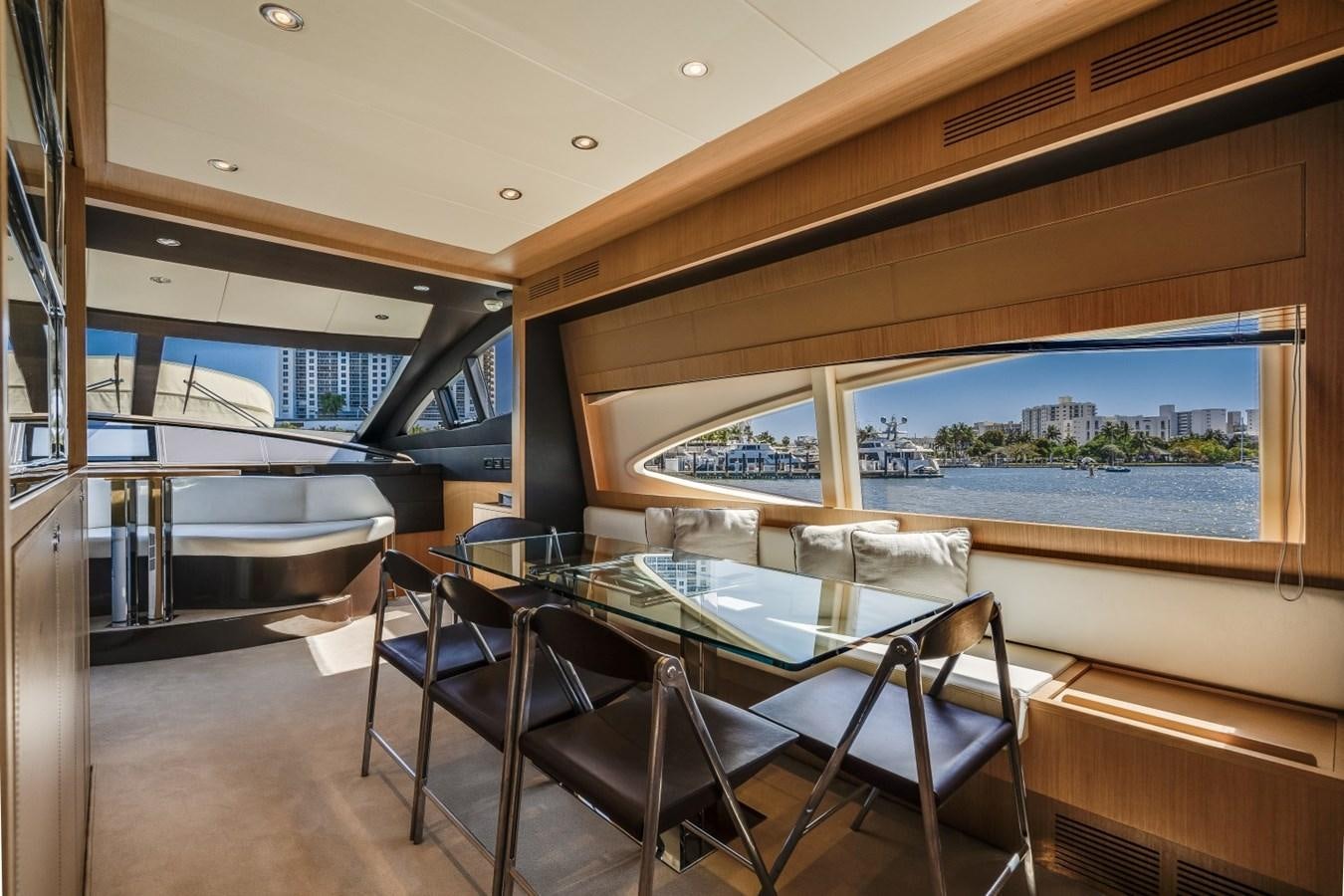 a room with a table and chairs aboard NAMEDROPPER Yacht for Sale