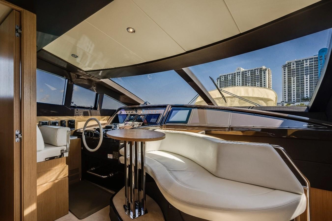 a room with a table and a window with a view of the city aboard NAMEDROPPER Yacht for Sale