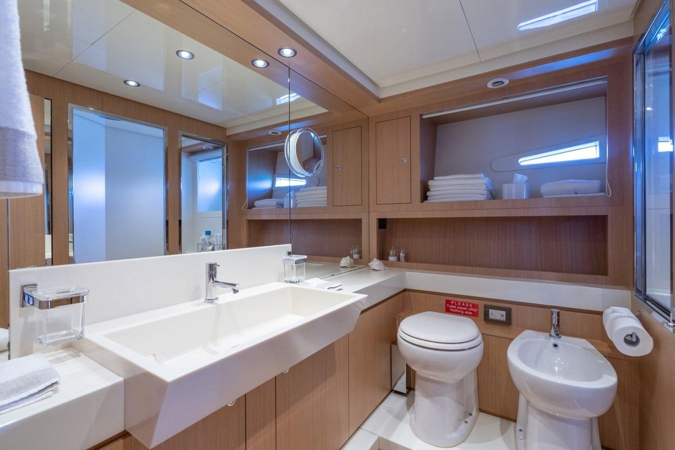 a bathroom with a large mirror aboard NAMEDROPPER Yacht for Sale