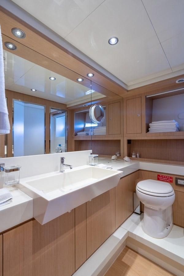 a bathroom with a large mirror aboard NAMEDROPPER Yacht for Sale