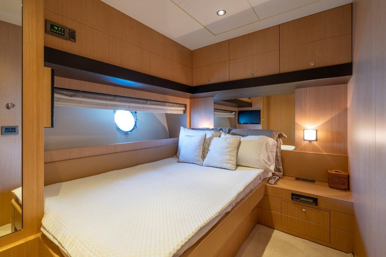 a room with a bed and a television aboard NAMEDROPPER Yacht for Sale
