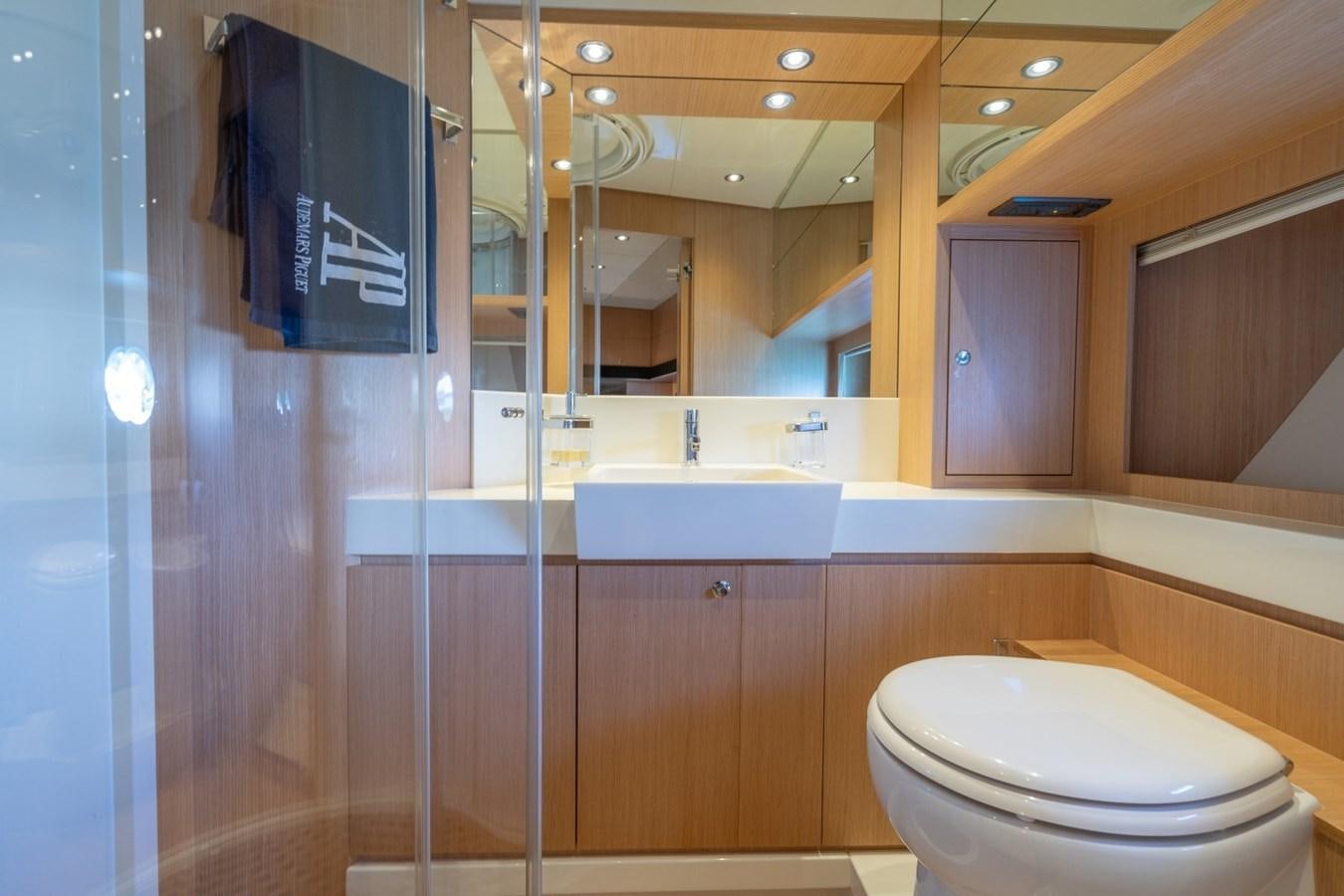a bathroom with a toilet and a sink aboard NAMEDROPPER Yacht for Sale