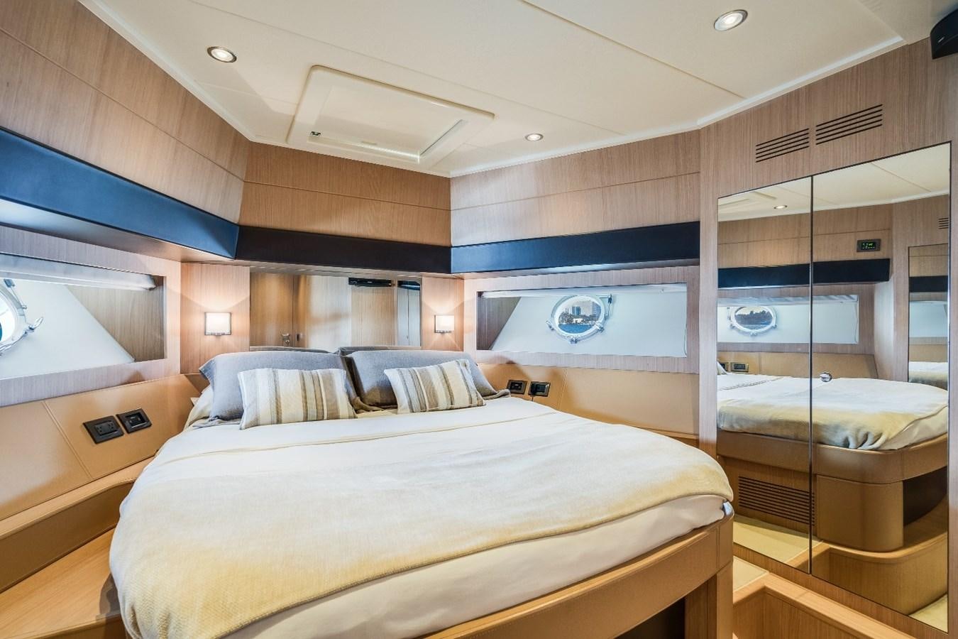a room with a bed and a television aboard NAMEDROPPER Yacht for Sale
