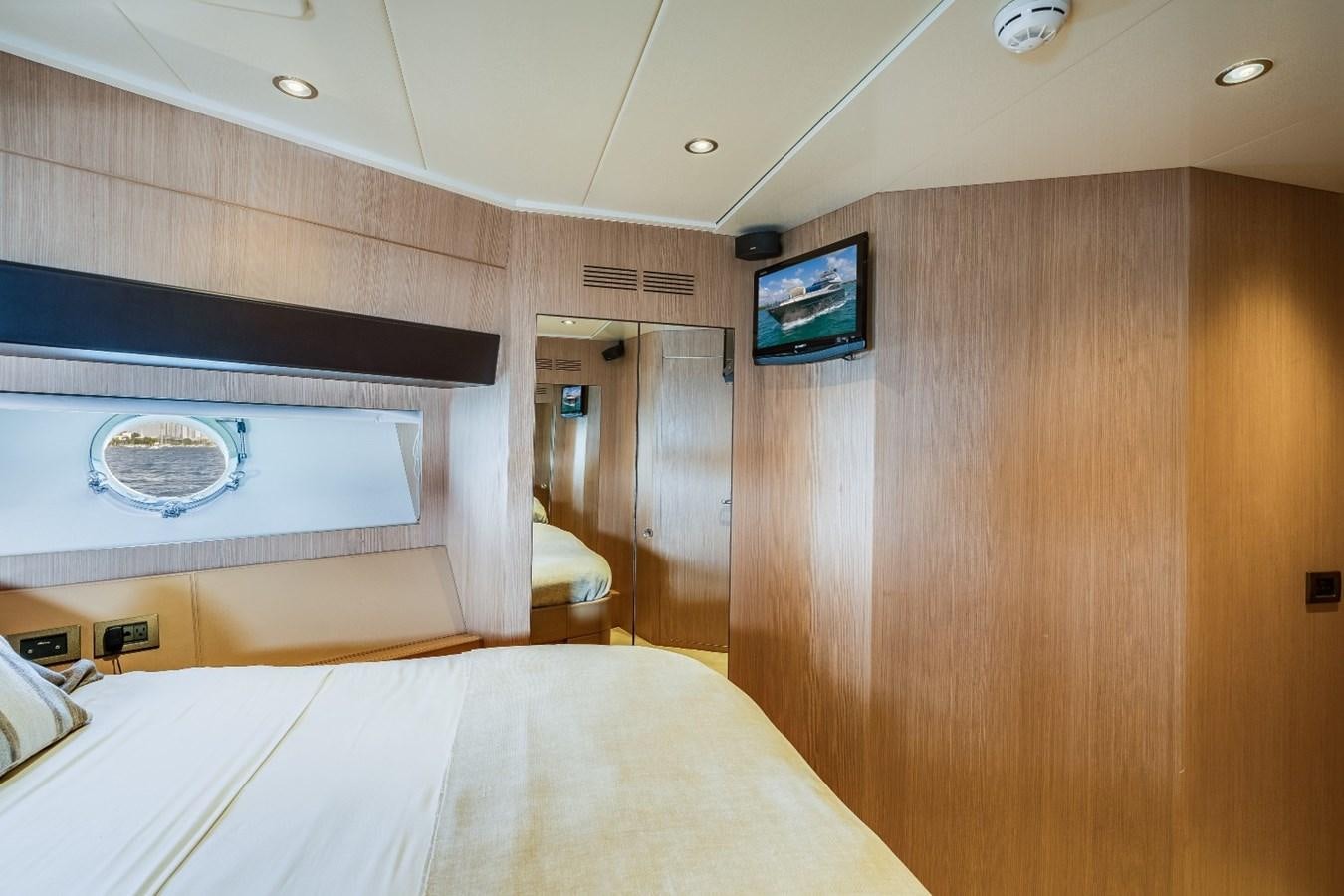 a room with a bed and a television aboard NAMEDROPPER Yacht for Sale