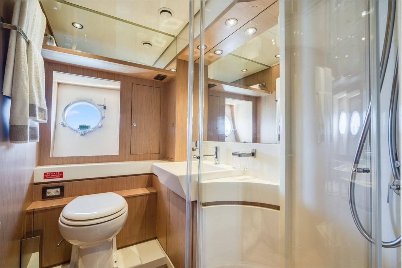 a bathroom with a glass shower aboard NAMEDROPPER Yacht for Sale