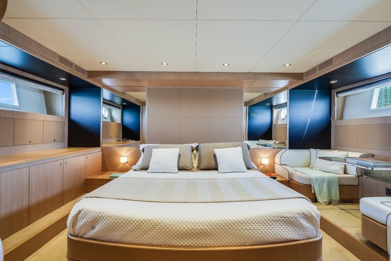 a room with a bed and a couch aboard NAMEDROPPER Yacht for Sale
