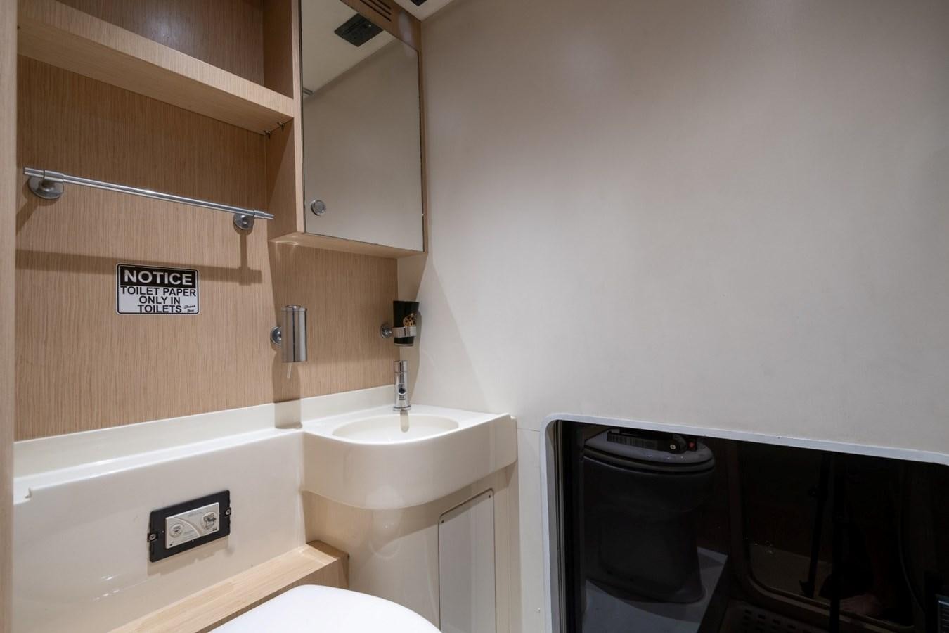 a bathroom with a sink and a toilet aboard NAMEDROPPER Yacht for Sale