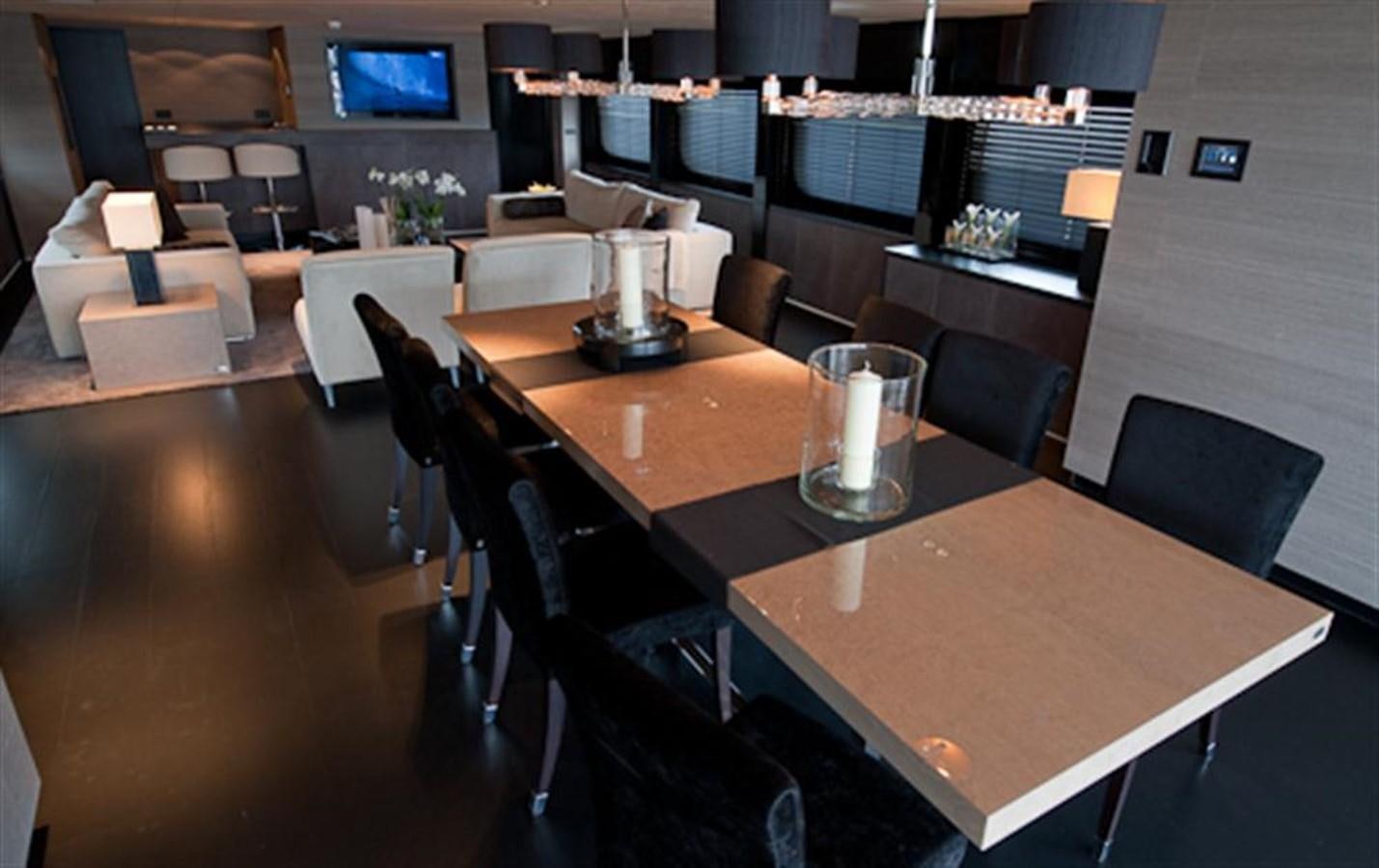 a table with chairs and a glass on it aboard LATITUDE Yacht for Charter