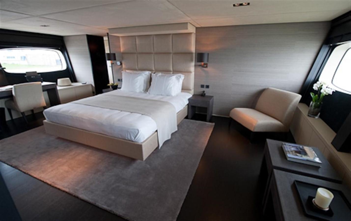 a room with a bed and a chair aboard LATITUDE Yacht for Charter