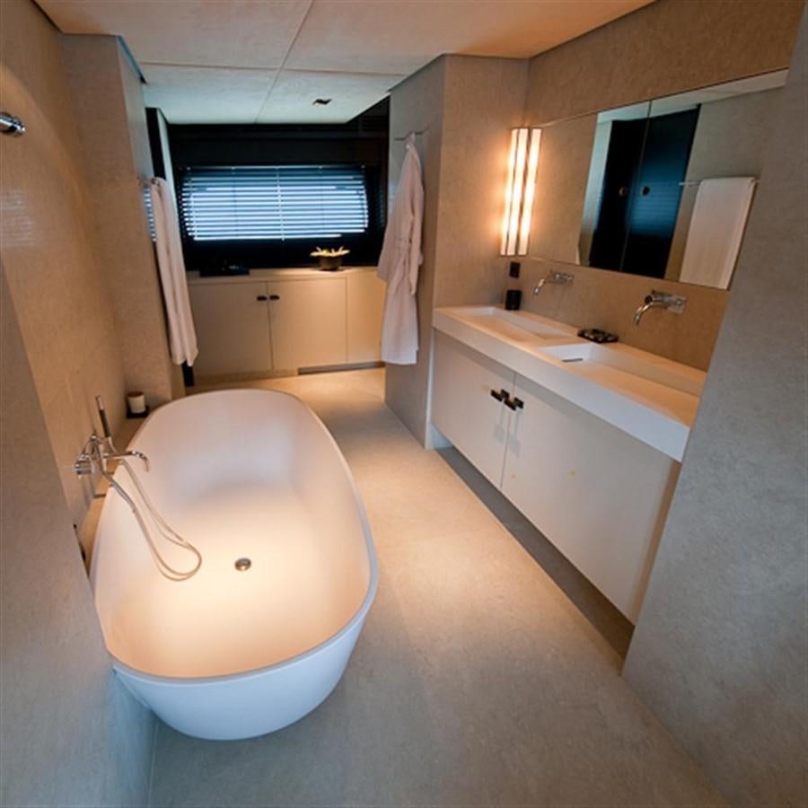 a bathroom with a toilet and sink aboard LATITUDE Yacht for Charter