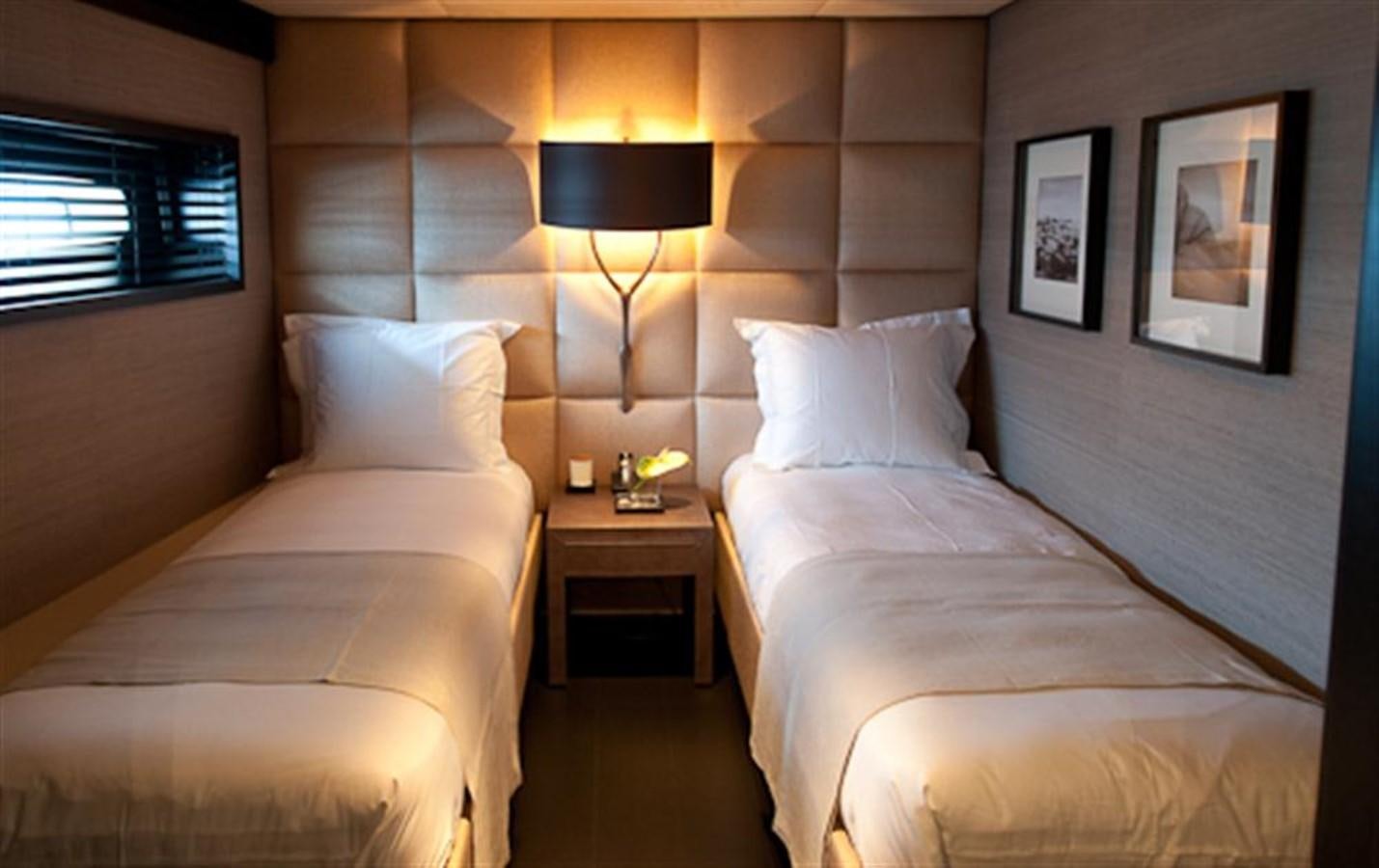 a room with two beds aboard LATITUDE Yacht for Charter
