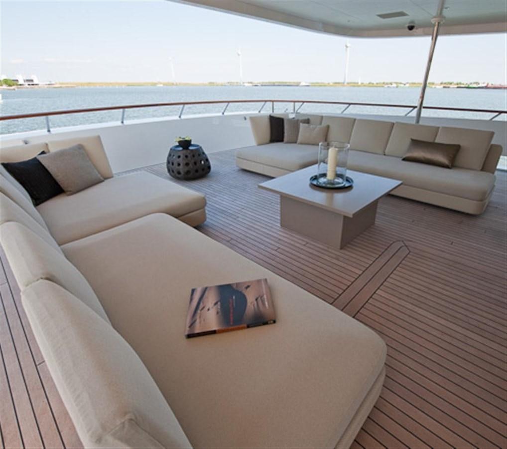 a living room with a couch and a table aboard LATITUDE Yacht for Charter