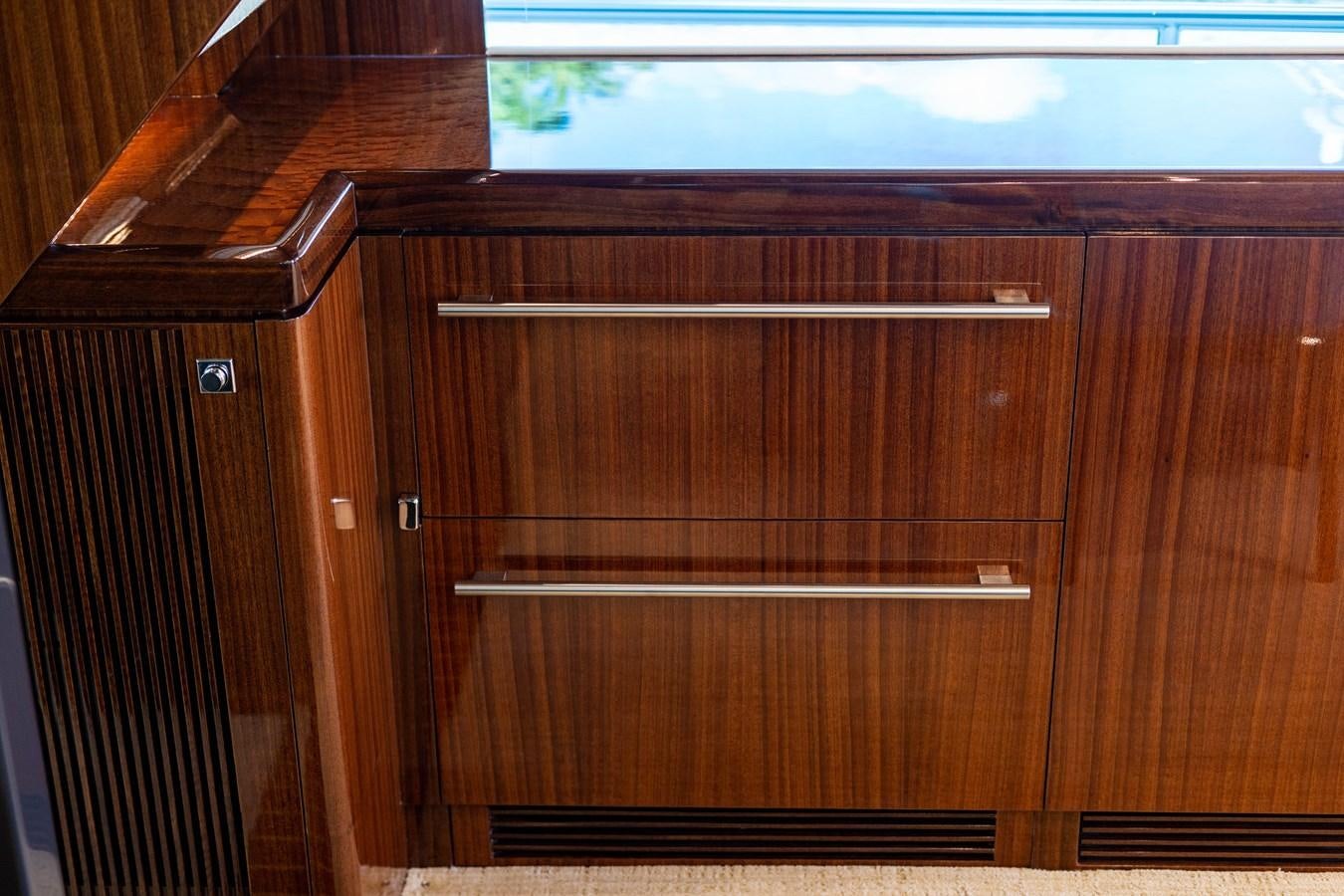 a wooden cabinet with drawers aboard SPREZZATURA Yacht for Sale
