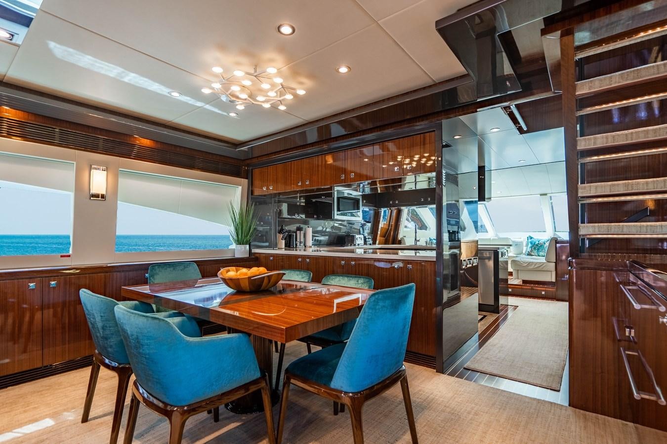 a kitchen with a table and chairs aboard SPREZZATURA Yacht for Sale