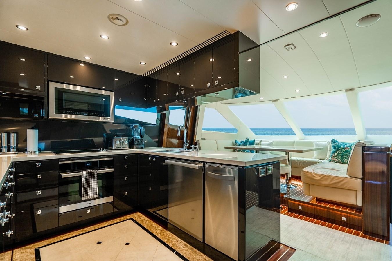 a kitchen with black cabinets aboard SPREZZATURA Yacht for Sale