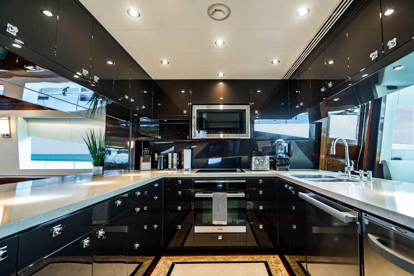a kitchen with black counters aboard SPREZZATURA Yacht for Sale