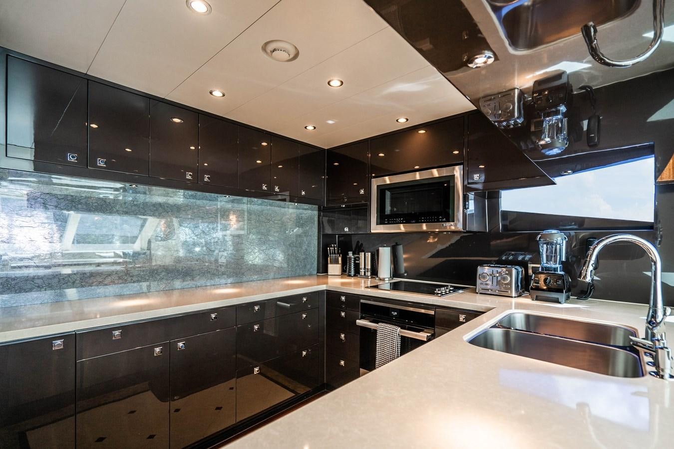 a kitchen with black cabinets aboard SPREZZATURA Yacht for Sale