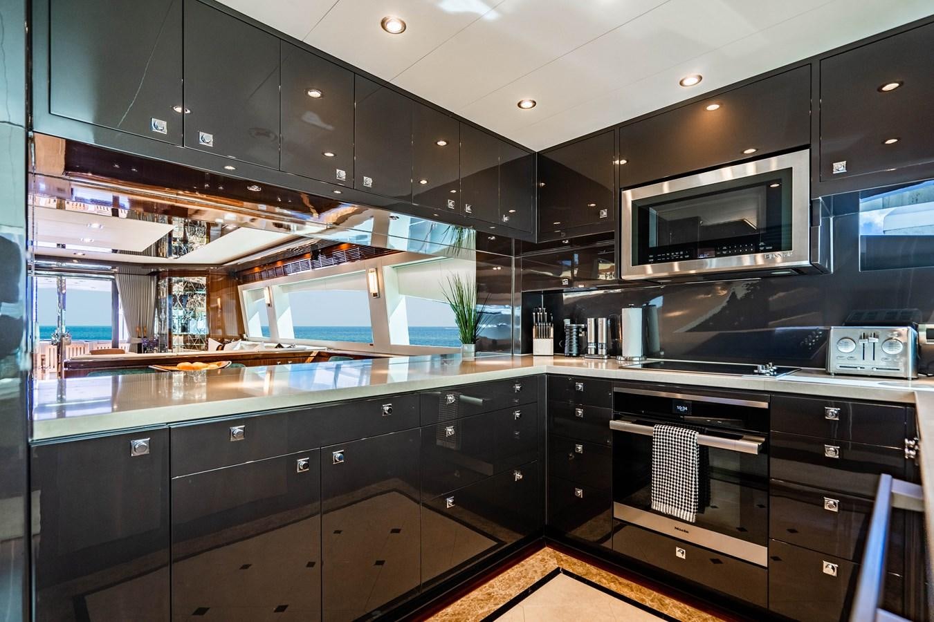 a kitchen with black cabinets aboard SPREZZATURA Yacht for Sale