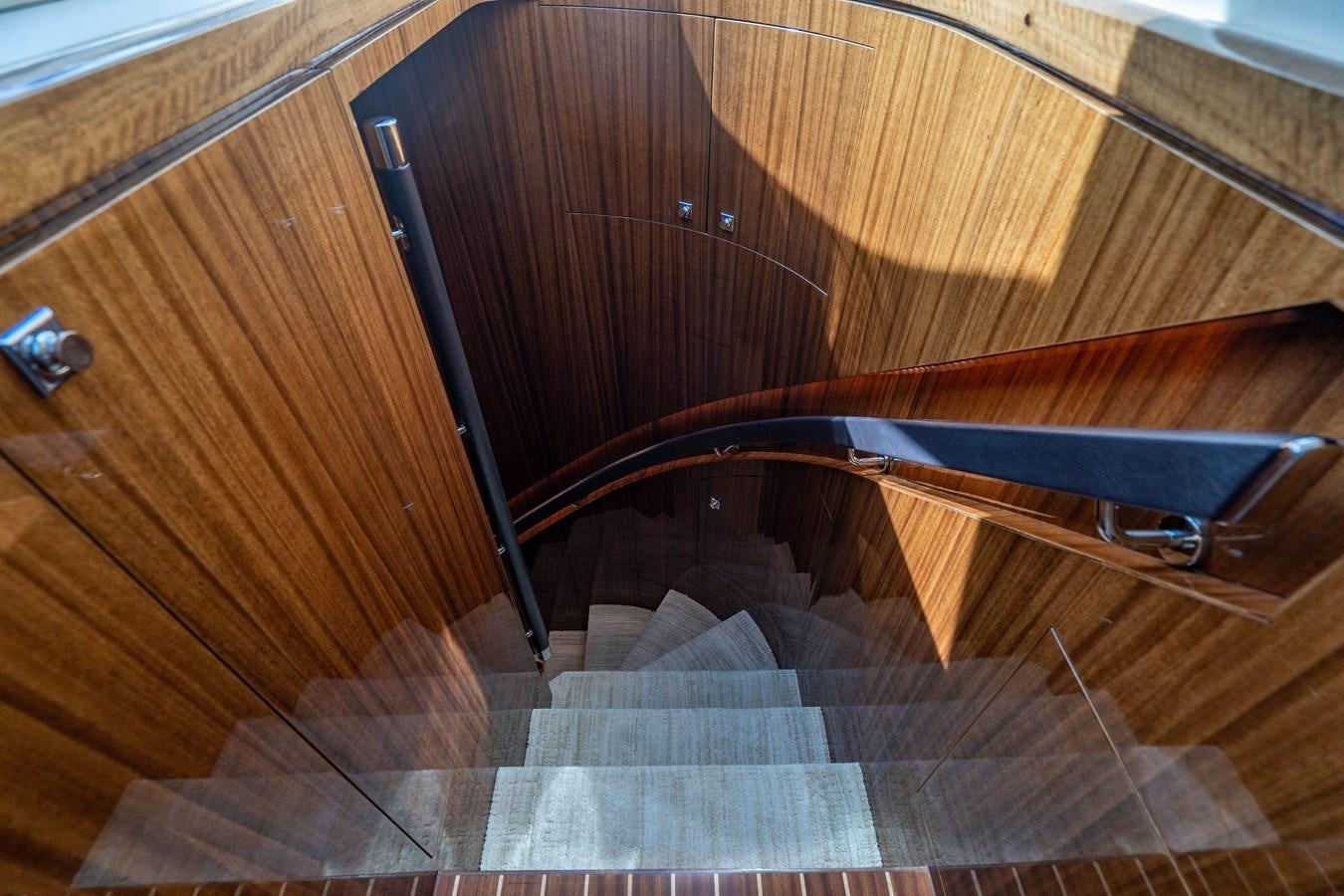 a wooden staircase with a metal railing aboard SPREZZATURA Yacht for Sale