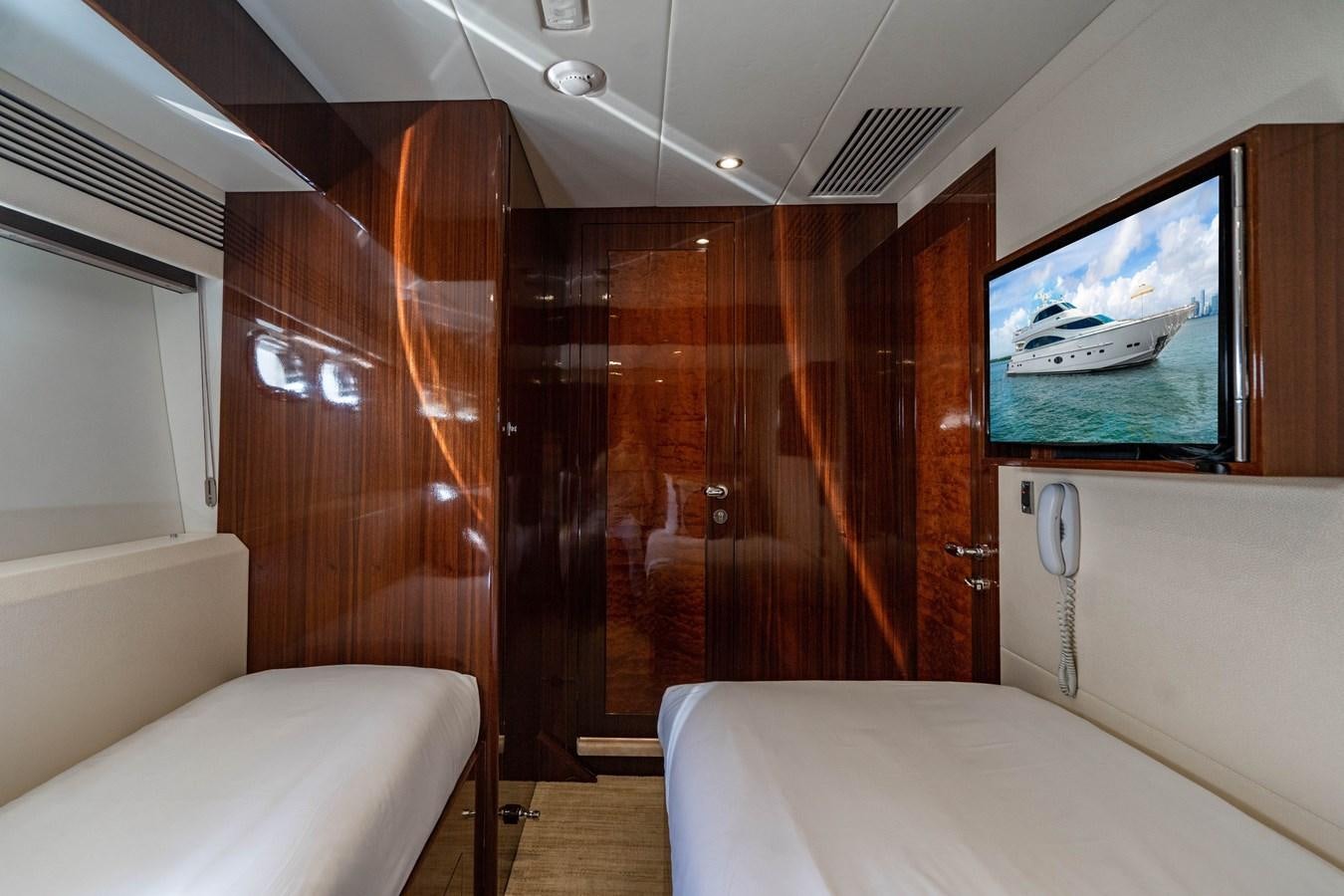 a room with a bed and a television aboard SPREZZATURA Yacht for Sale