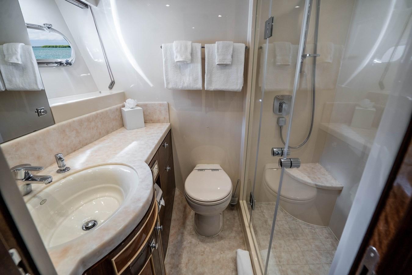 a bathroom with a shower sink and toilet aboard SPREZZATURA Yacht for Sale
