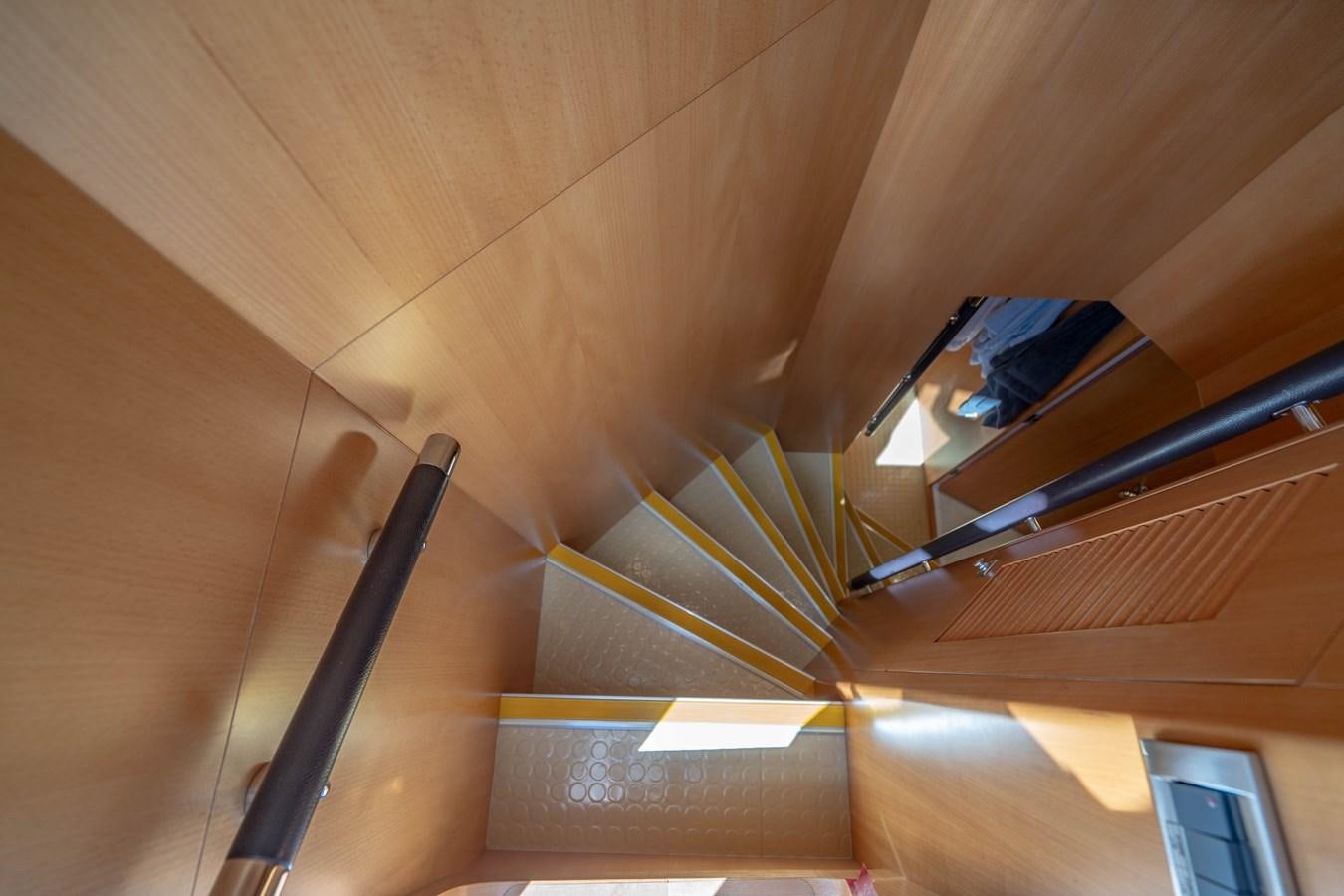 a wooden staircase with a spiral staircase aboard SPREZZATURA Yacht for Sale