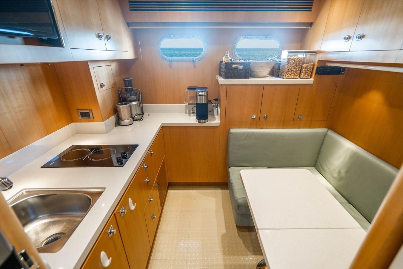 a kitchen with a couch and a table aboard SPREZZATURA Yacht for Sale