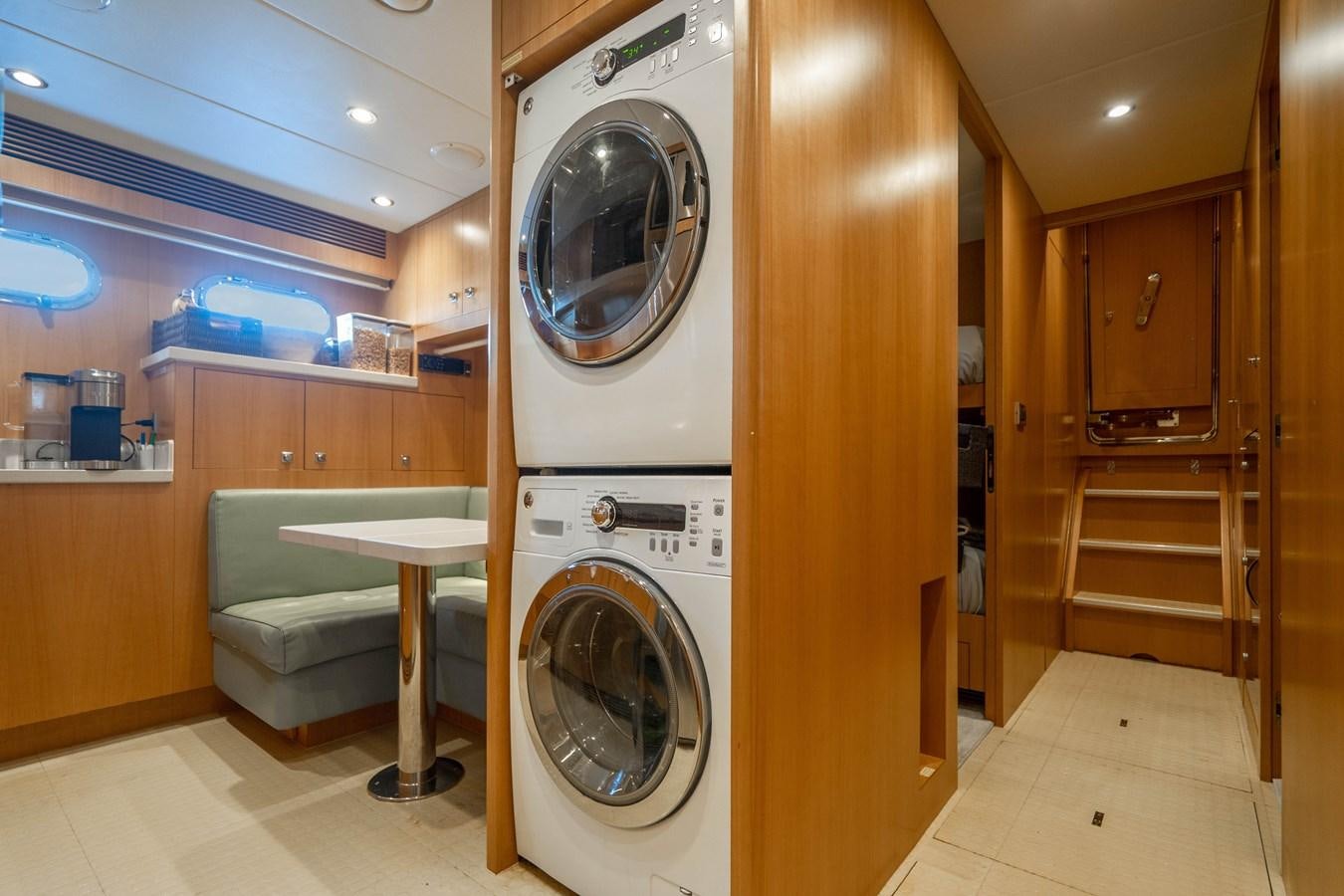 a room with a washing machine and a table aboard SPREZZATURA Yacht for Sale