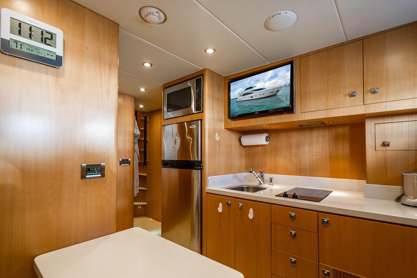 a kitchen with wooden cabinets aboard SPREZZATURA Yacht for Sale