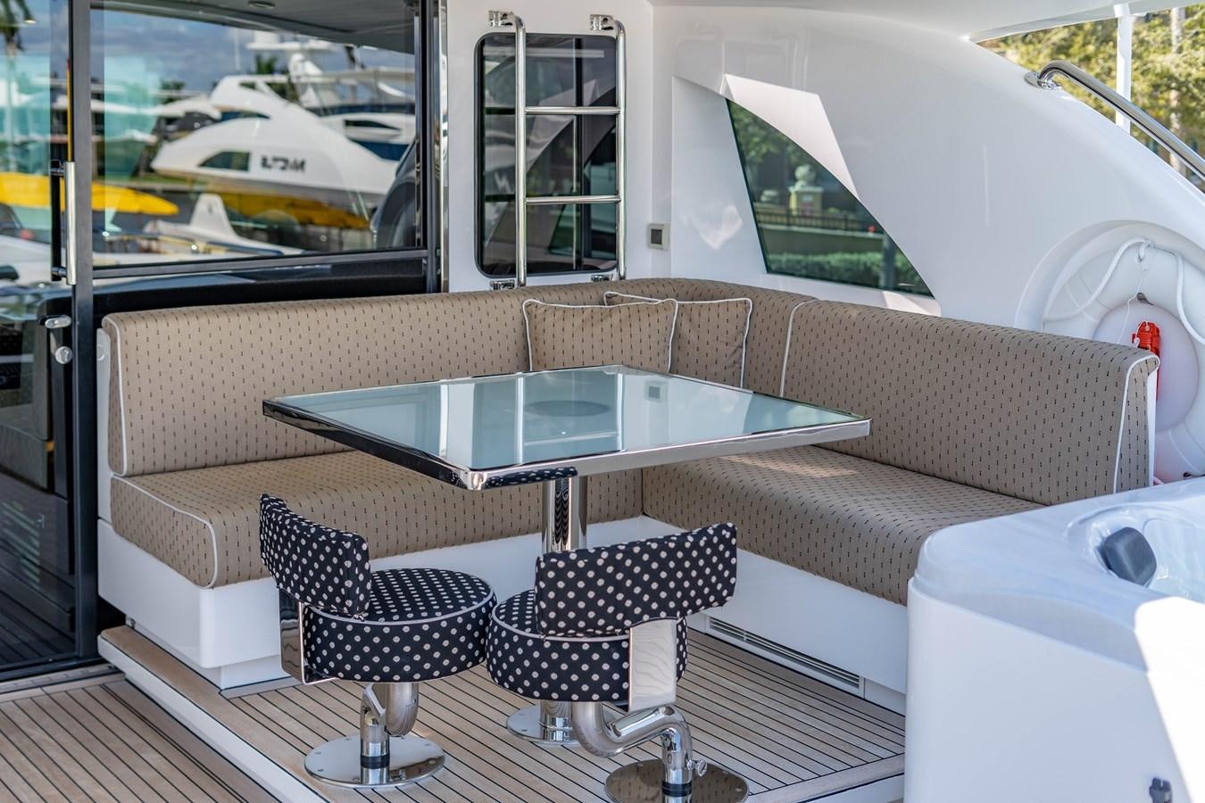 a couch and chairs on a deck aboard SPREZZATURA Yacht for Sale