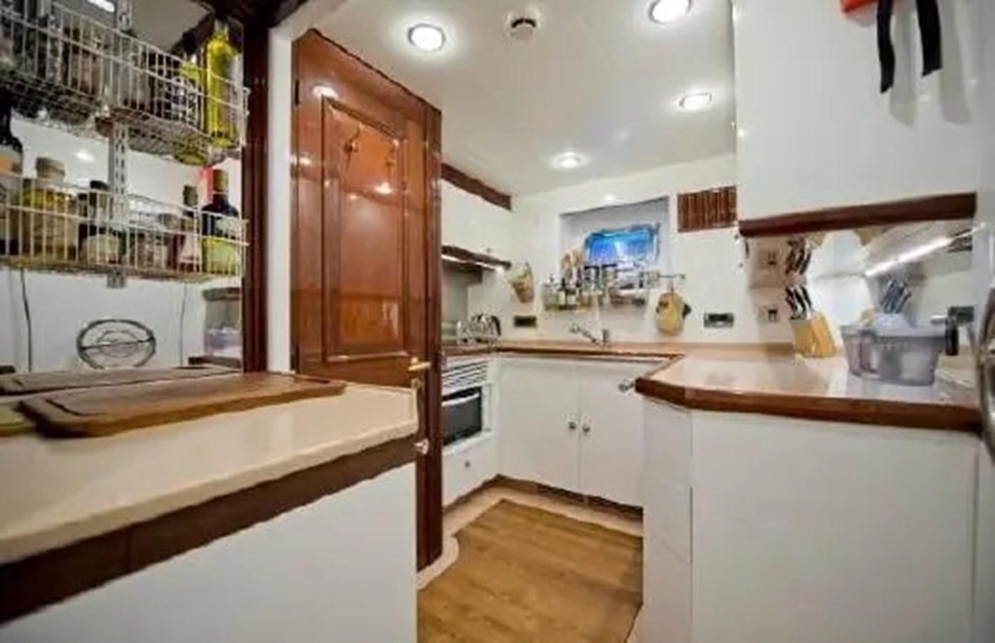 a kitchen with a wooden door aboard GRAND AZURE  Yacht for Sale