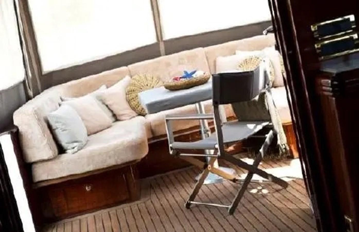 a couch and a chair in a room aboard GRAND AZURE  Yacht for Sale