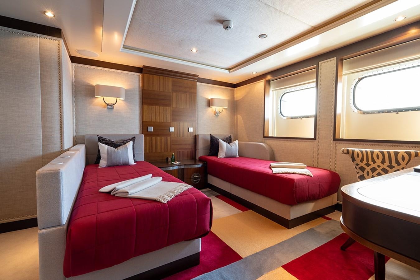 a room with a red couch and a red bed aboard KAISER Yacht for Sale