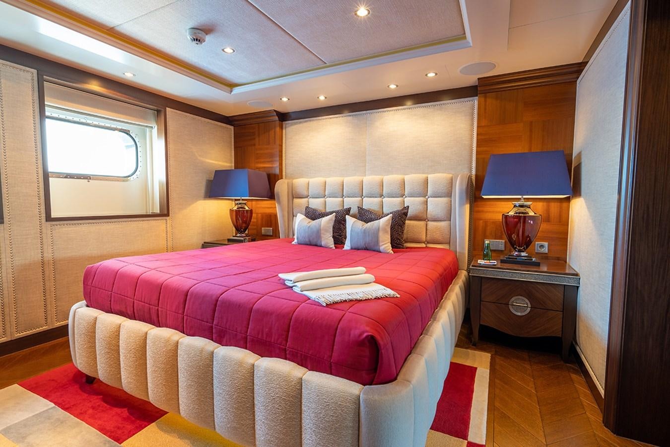a bedroom with a bed and a lamp aboard KAISER Yacht for Sale