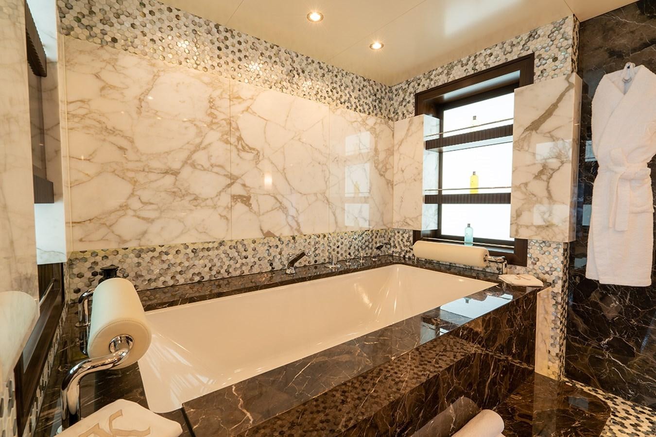 a large bathtub with marble tiles aboard KAISER Yacht for Sale