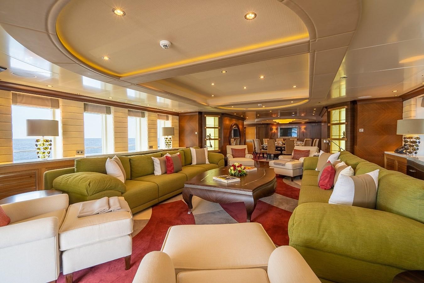 a living room with a couch and a table aboard KAISER Yacht for Sale