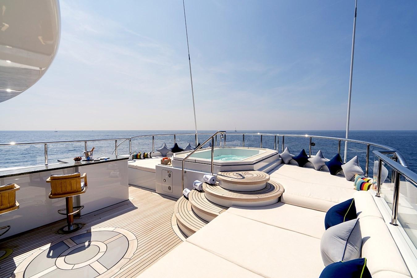 a room with a view of the ocean and a deck with a large ship on it aboard KAISER Yacht for Sale