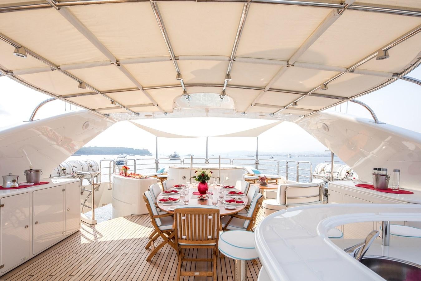 a room with tables and chairs aboard BLUE VISION Yacht for Charter
