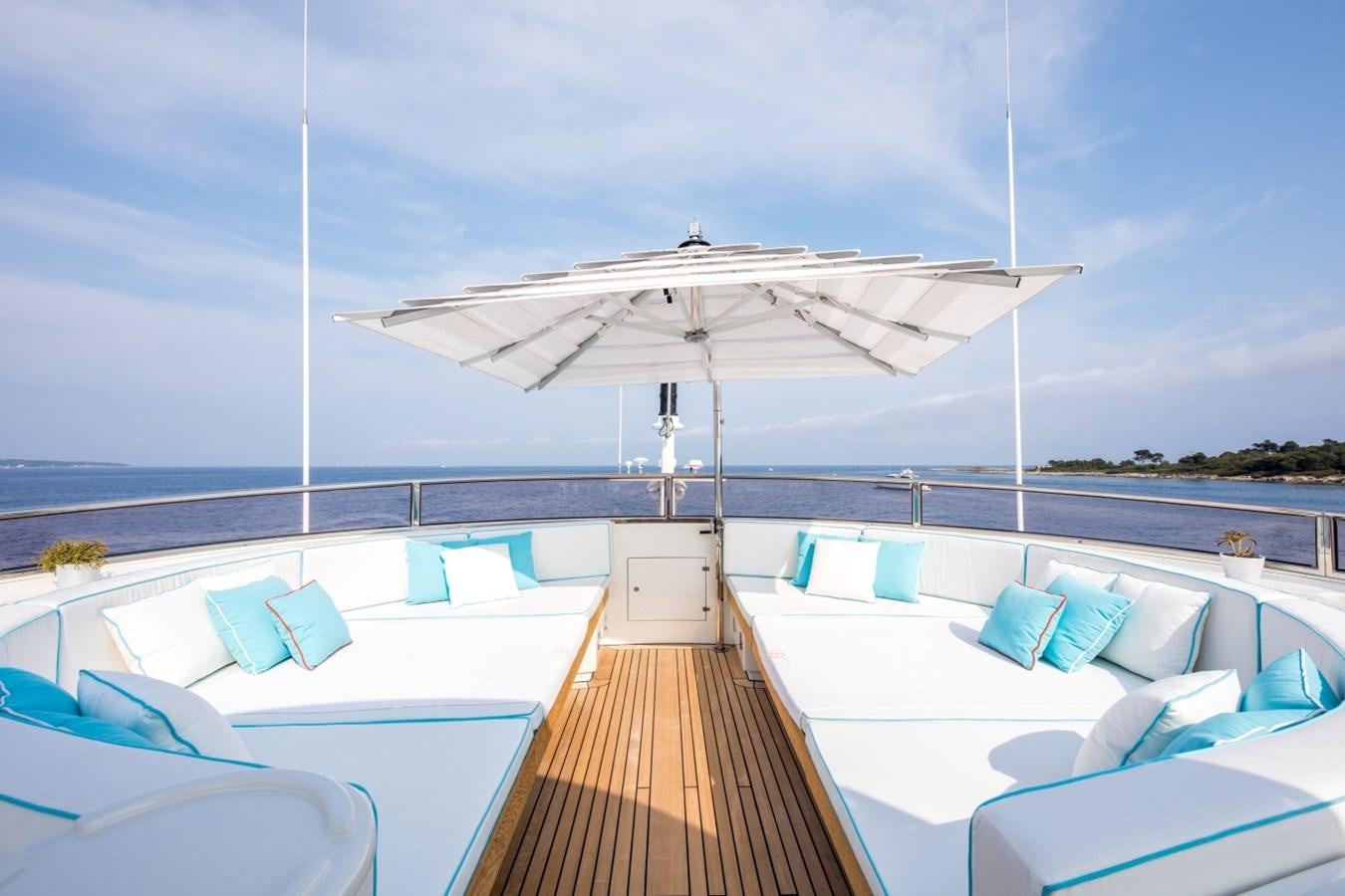a deck with a large white umbrella aboard BLUE VISION Yacht for Charter