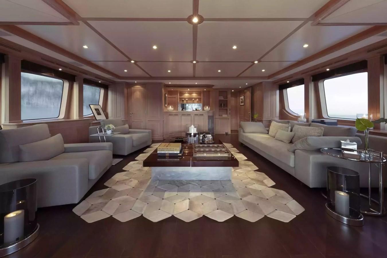 a living room with a table and couches aboard SOHO Yacht for Charter