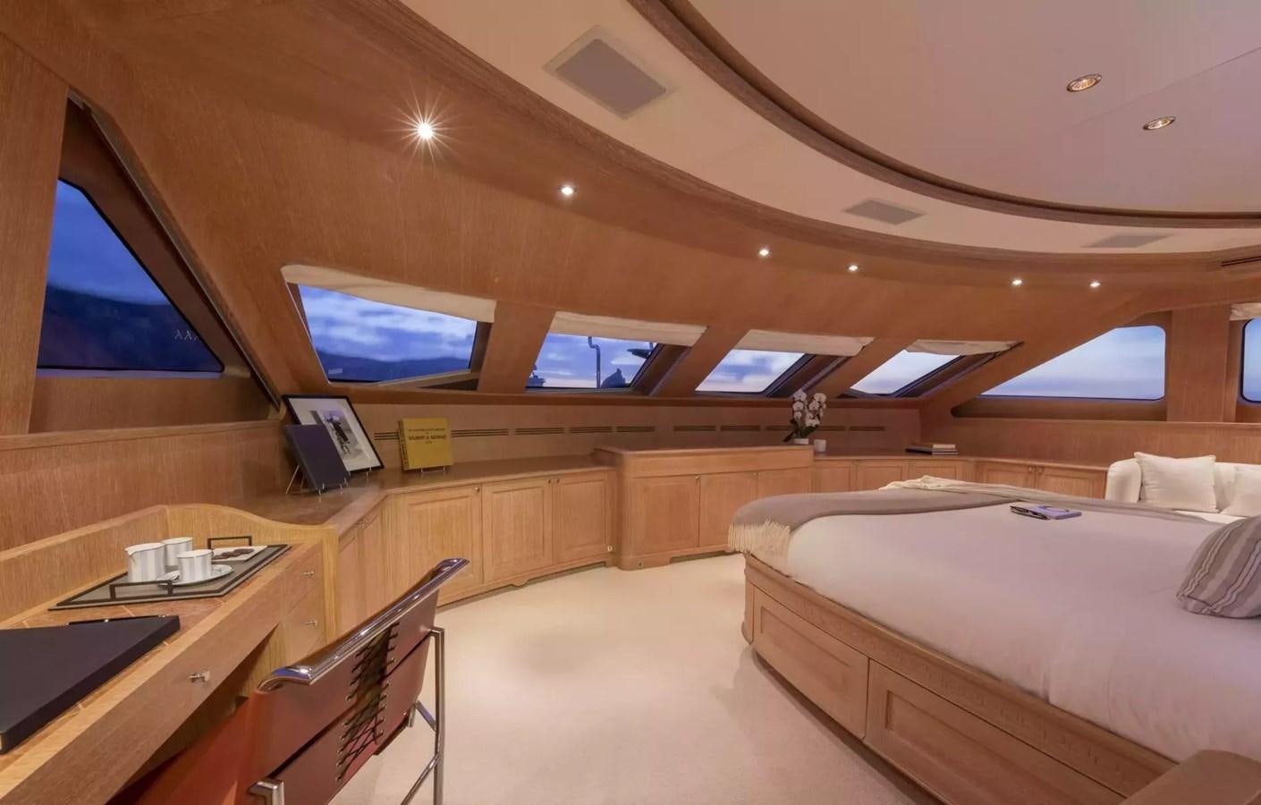 a room with a bed and a desk aboard SOHO Yacht for Charter