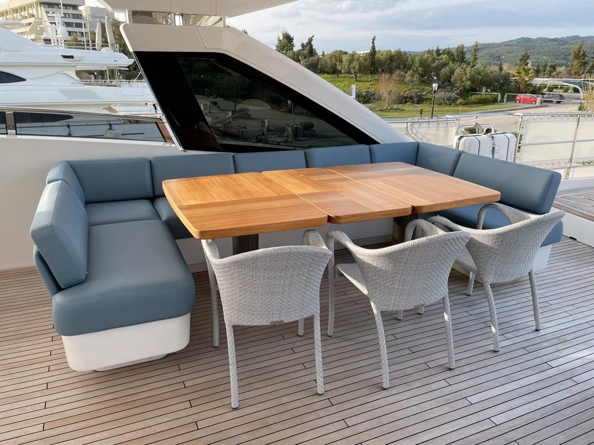 a table and chairs on a patio aboard AFON Yacht for Sale