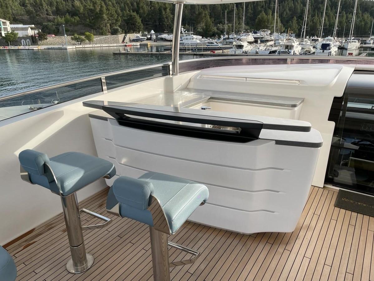 a table and chairs on a deck aboard AFON Yacht for Sale