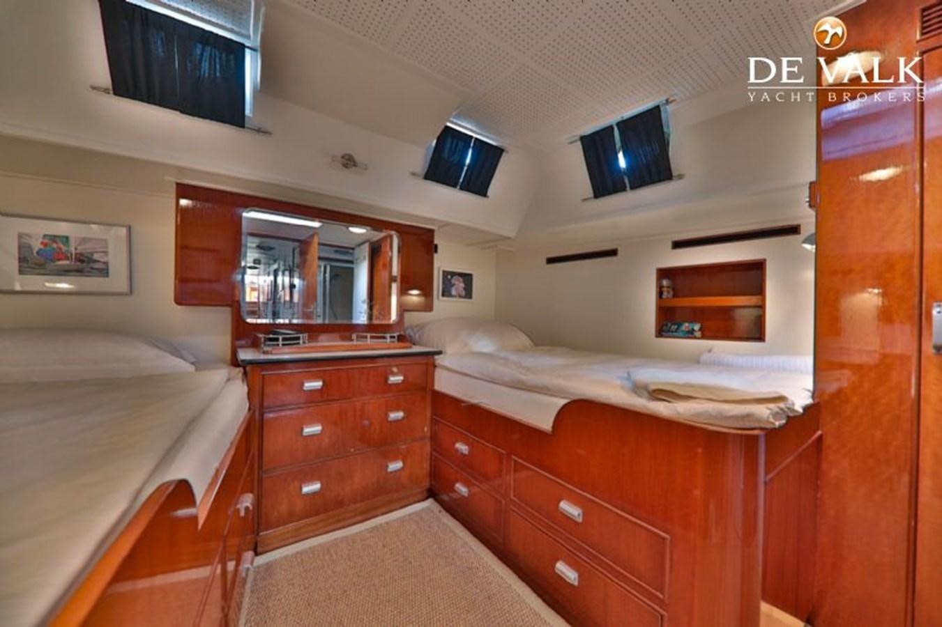 a room with a bed and a television aboard ATALANTA J Yacht for Sale